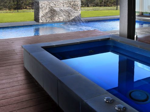 Fibreglass pool with a self standing spa
