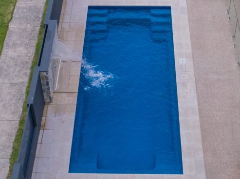 Contemporary pool with water wall from above