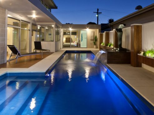 Fastlane pool for swimming laps with water wall feature and lights