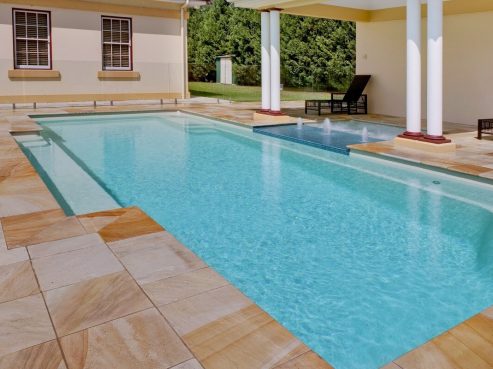 Mark Pollard Pools Vogue fibreglass family swimming pool with a spa and water feature attached